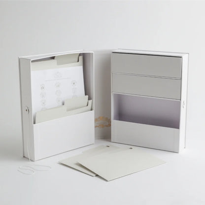 An open view of the baby keepsake organizer, showcasing multiple compartments, storage drawers, and labeled folders for preserving important baby milestones.