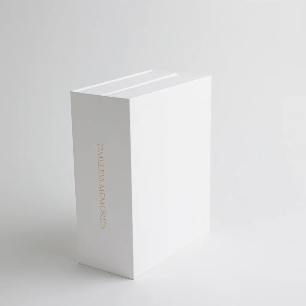 A book-style keepsake box standing upright, featuring "Timeless Memories" embossed in gold, adding a vintage and elegant touch.
