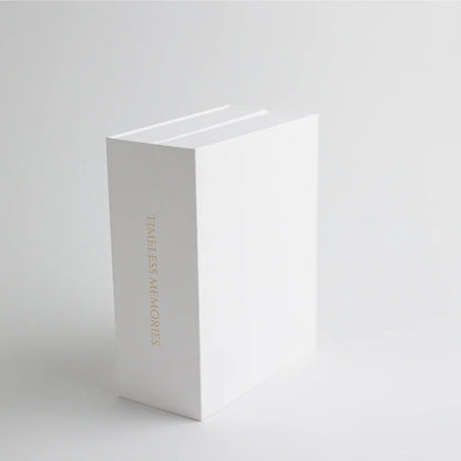 A book-style keepsake box standing upright, featuring "Timeless Memories" embossed in gold, adding a vintage and elegant touch.