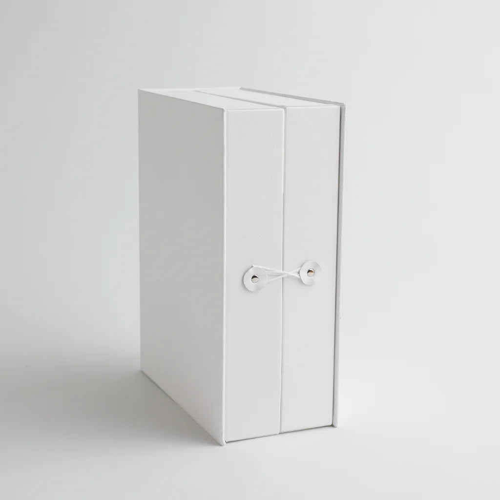 A front view of the keepsake organizer with a secure string closure, designed to keep precious baby mementos safe and neatly stored.