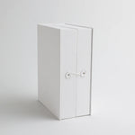 A front view of the keepsake organizer with a secure string closure, designed to keep precious baby mementos safe and neatly stored.