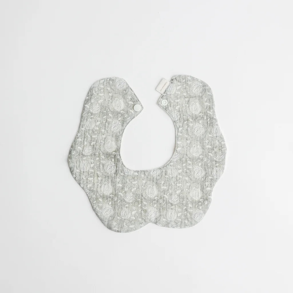 A sophisticated sage green baby bib featuring a vintage lace-inspired pattern, perfect for stylish and practical babywear.