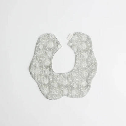 A sophisticated sage green baby bib featuring a vintage lace-inspired pattern, perfect for stylish and practical babywear.