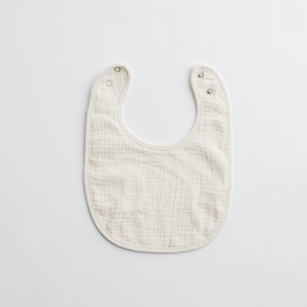Another white muslin baby bib with a slightly different texture, made for delicate baby skin.
