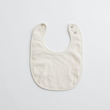 Another white muslin baby bib with a slightly different texture, made for delicate baby skin.
