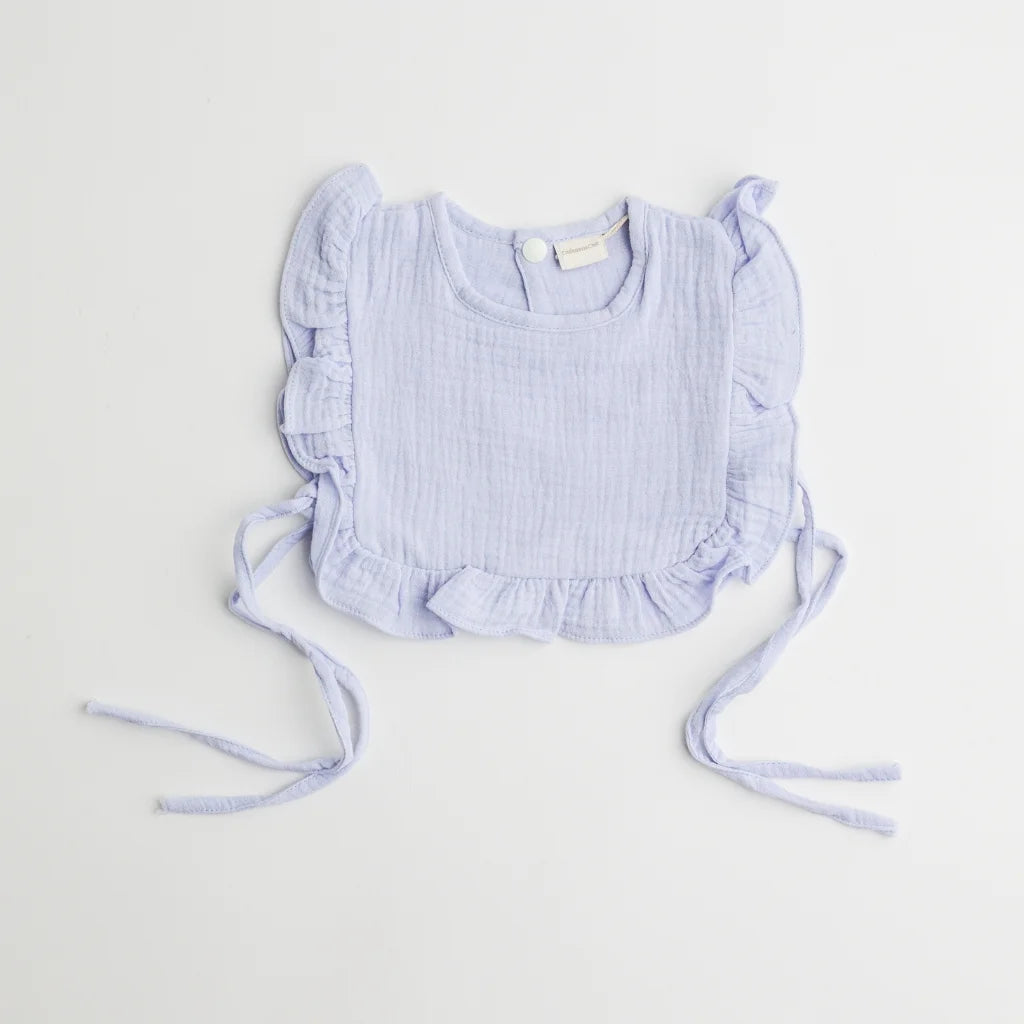 A pastel blue organic muslin ruffle bib with charming frill accents, designed for style and functionality.