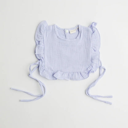A pastel blue organic muslin ruffle bib with charming frill accents, designed for style and functionality.