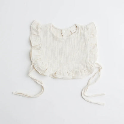 A classic ivory muslin ruffle bib with ruffled trim, offering an elegant and breathable fabric for babies.