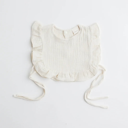 A classic ivory muslin ruffle bib with ruffled trim, offering an elegant and breathable fabric for babies.