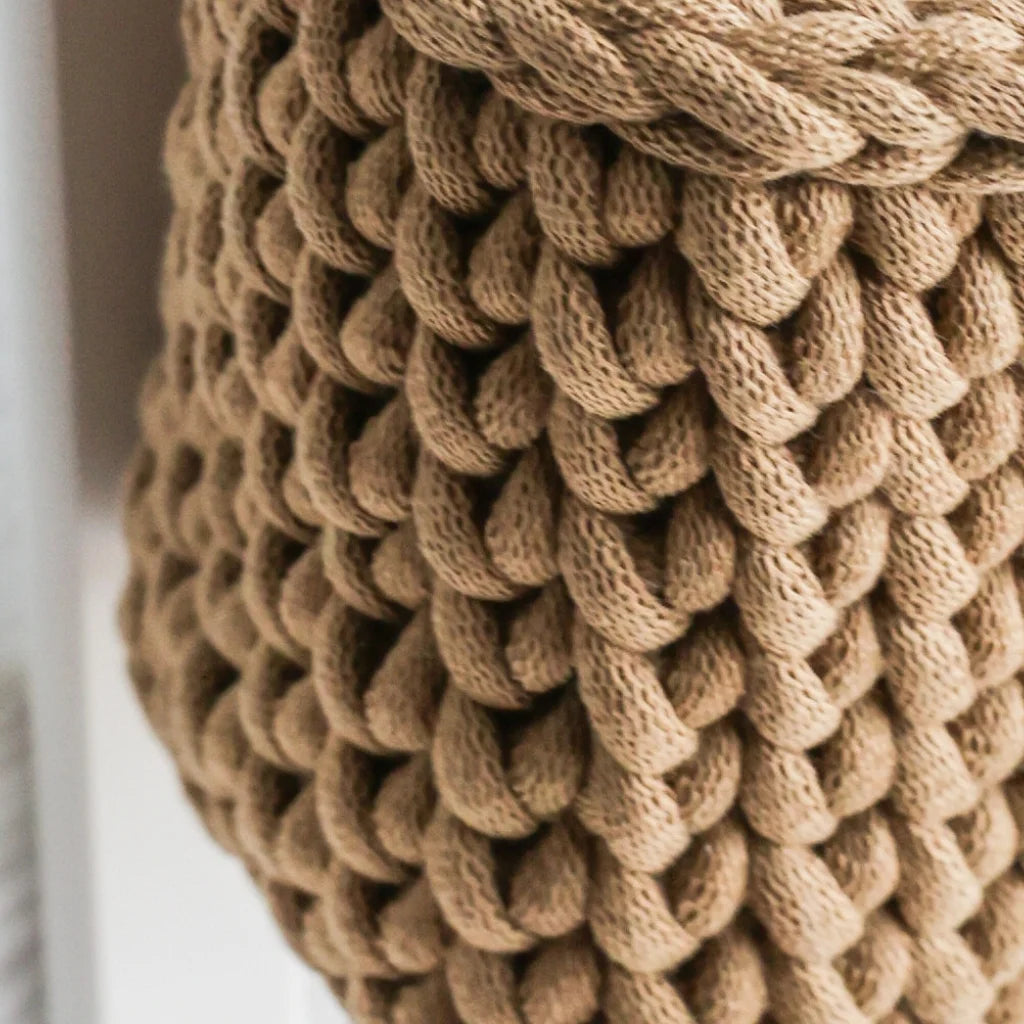 A detailed close-up of the thickly woven texture of the brown knit crib organizer, highlighting its premium organic cotton material and durable craftsmanship.