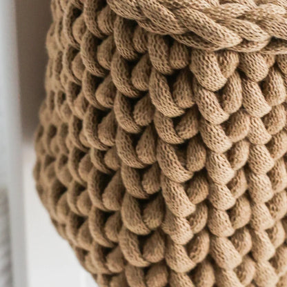 A detailed close-up of the thickly woven texture of the brown knit crib organizer, highlighting its premium organic cotton material and durable craftsmanship.