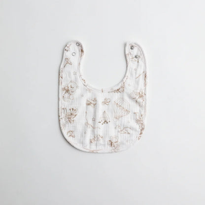 A classic muslin baby bib with a hand-drawn teddy bear and toy pattern in neutral brown tones.